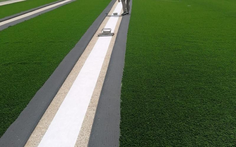Laying of the synthetic grass: laying of the adhesive strip underneath