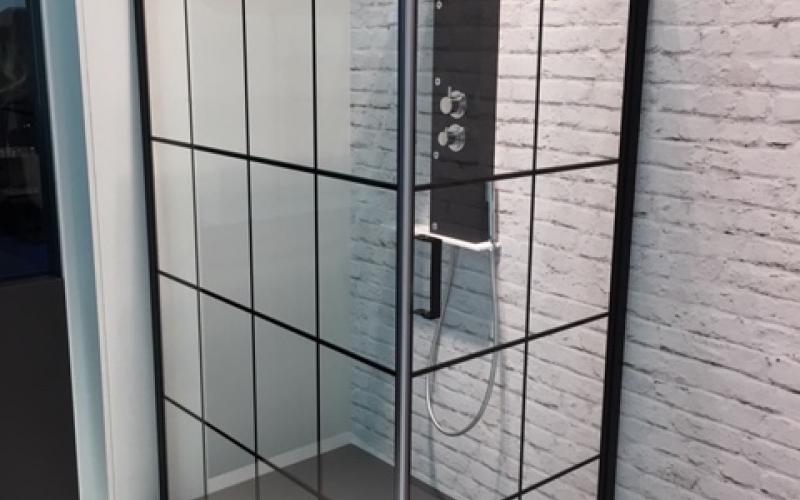 Shower enclosure with black outer frame and black panels
