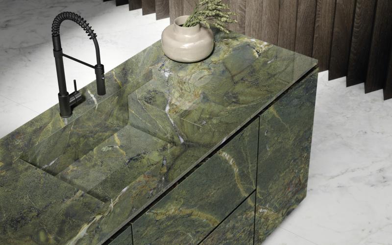 Large green marble-effect slabs used to clad a kitchen