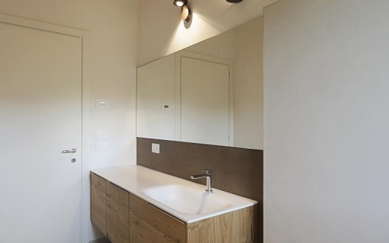 Wooden bathroom cabinet with Corian top in a bathroom in Vicenza