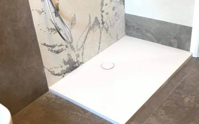A white corian shower tray laid in a bathroom in Vicenza